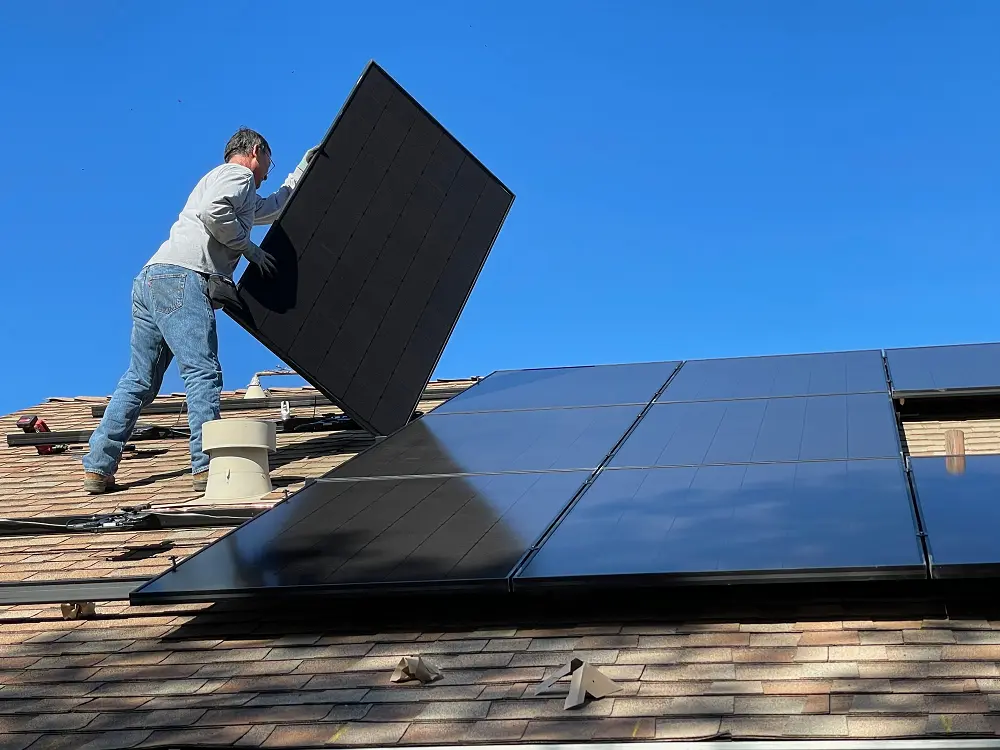 a worker in grey from ipromise setting up the solar panels